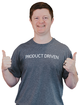A person wearing a gray "PRODUCT DRIVEN" t-shirt stands smiling and giving two thumbs up.