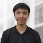 A young man with short black hair and a faint mustache, dressed in a black collared shirt, stands in front of a blurred background—an image reflective of backend developers who build robust APIs to scale modern applications.