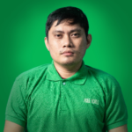 A man wearing a green polo shirt with "FULLCIRCLE" text, seated against a green background, represents custom software developers as he looks directly at the camera.