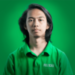 A person with long dark hair, wearing a green "FULL SCALE" polo shirt, poses against a green background—ideal imagery for businesses looking to hire full stack developers or connect with offshore full stack developers in the Philippines.