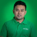 Man wearing a green "Full Scale" polo shirt poses against a green background, looking directly at the camera.